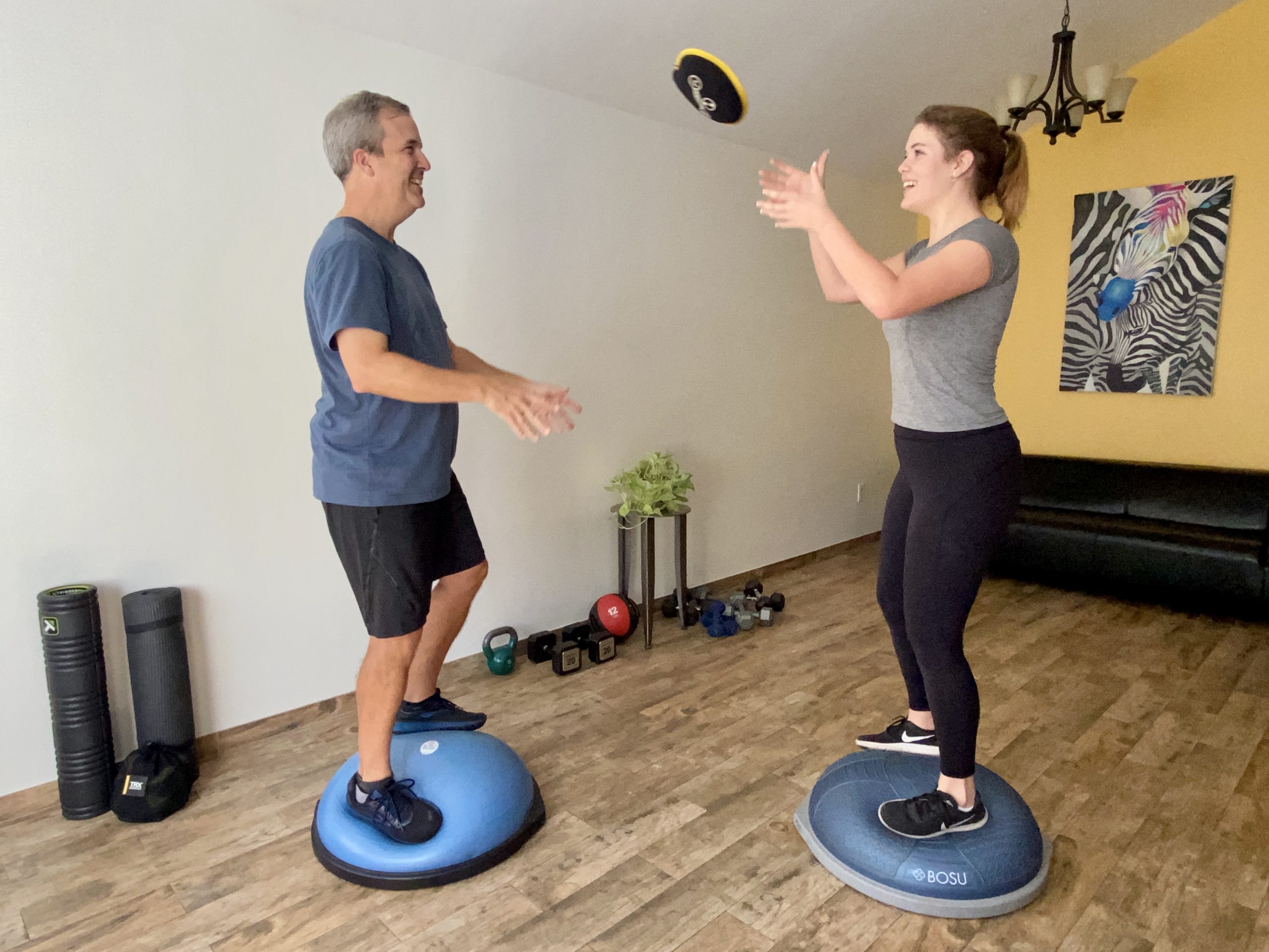 Father and daughter on Bosu balls